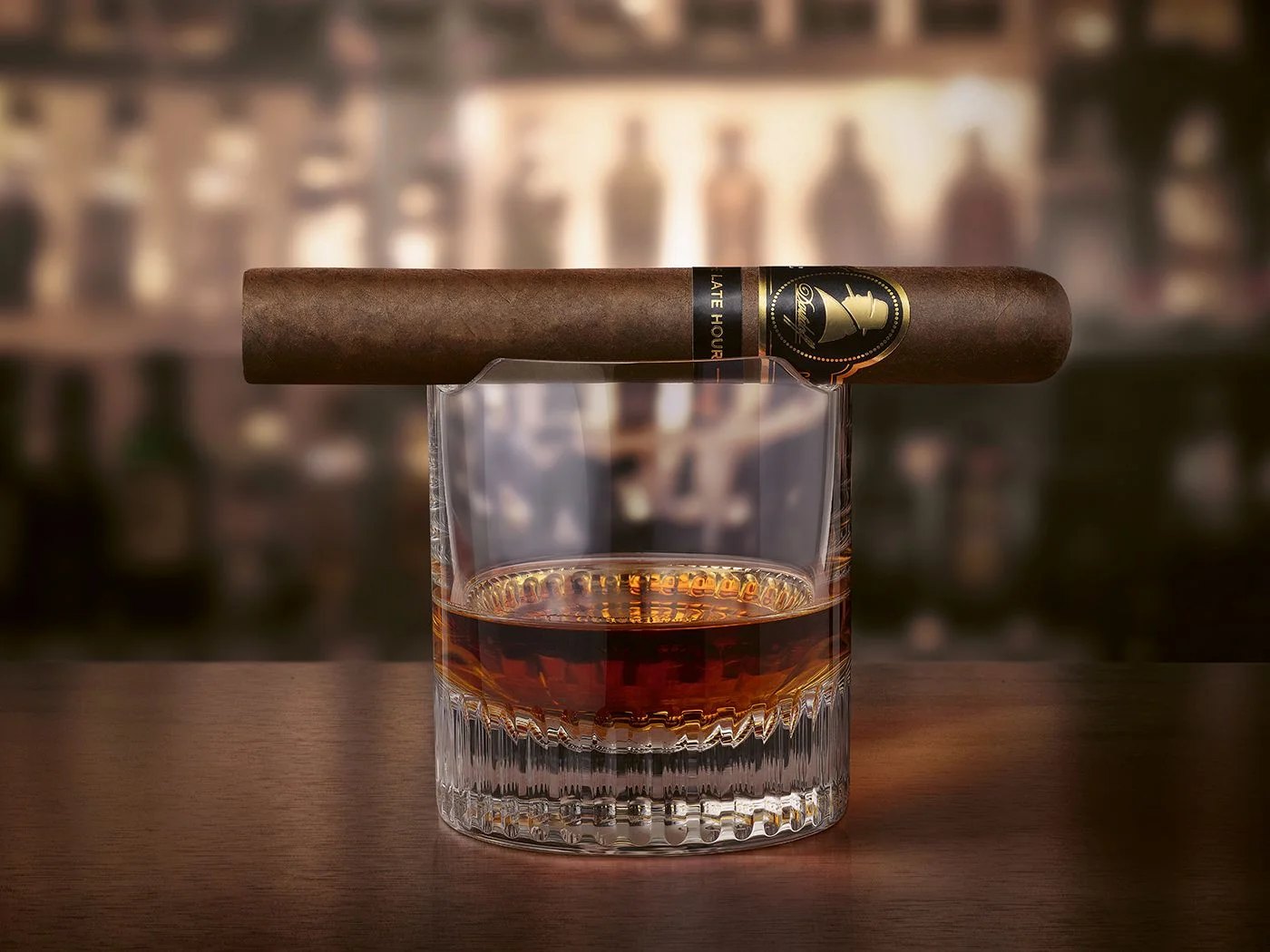 Davidoff Winston Churchill The Late Hour cigar resting on a glass of dark rum
